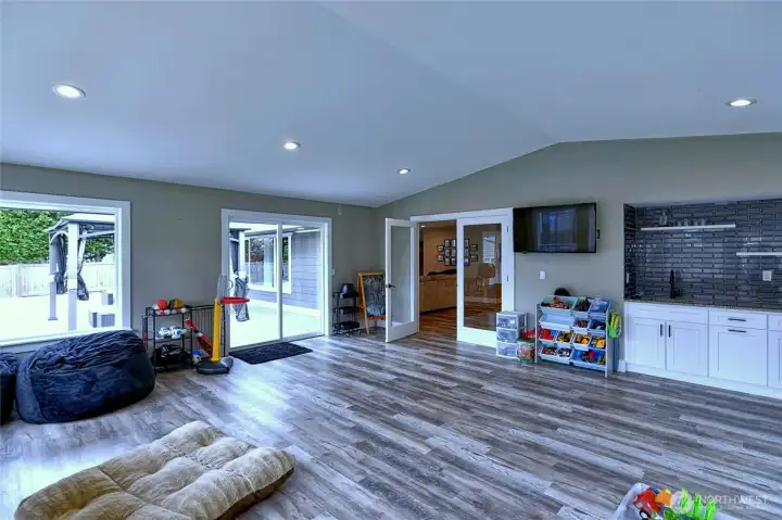 Spacious bonus room with built-in storage, sliding glass door goes to the back deck.
