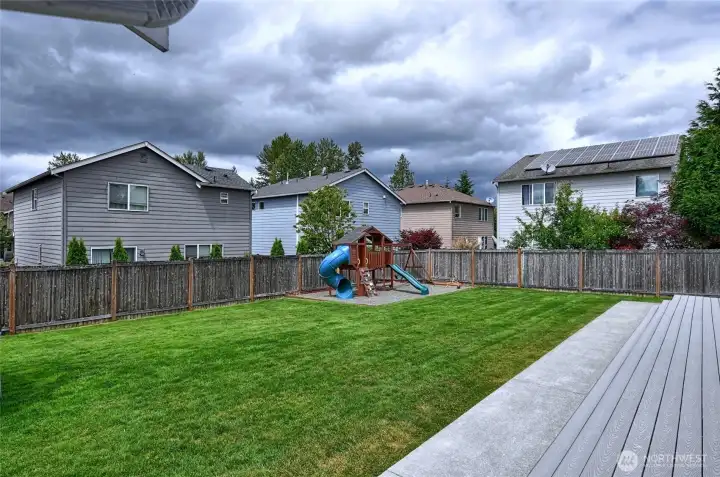 Backyard with lawn, play area, and patio