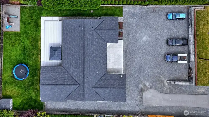 Overhead view of the home, yard, and parking