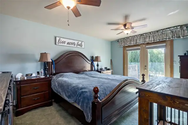 Primary Bedroom Main Floor. French Doors Lead to Back Patio