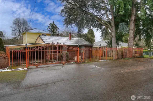 Classic brick home sits on a large lot. Rolling, gated entry leads to off street parking galore.