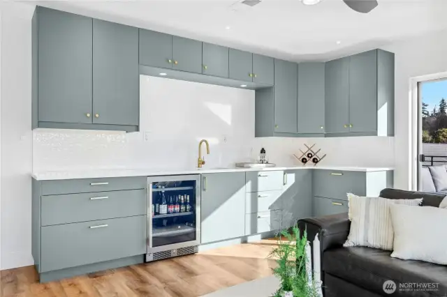 A deluxe wet-bar is the focal point of this fun room. Ample cabinetry, a prep sink with Grohe faucet, beverage refrigerator, and gorgeous tile are found here.
