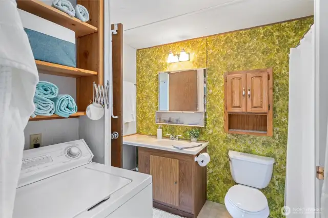 Convenient in-home laundry setup with built-in storage—just what you need for sandy beach towels and weekend escapes.