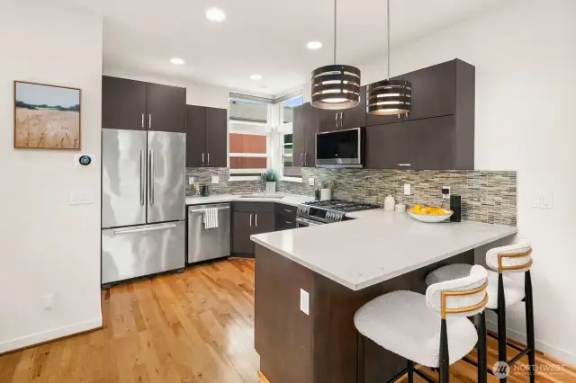 Open concept living/dining/kitchen w/ gas fireplace & floor to ceiling windows