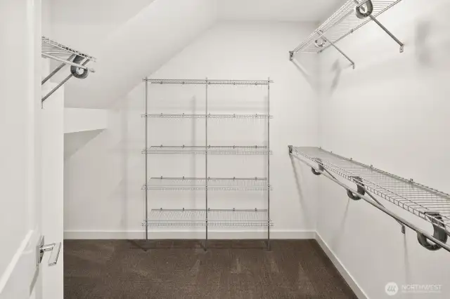 Upper level primary suite w/ walk-in closet & expansive en-suite bath