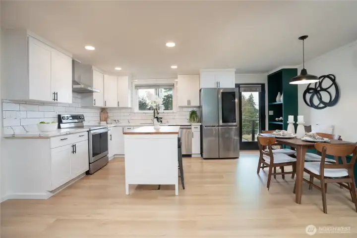 Bright, inviting kitchen-dining space with warm wood tones and layered natural and recessed lighting.