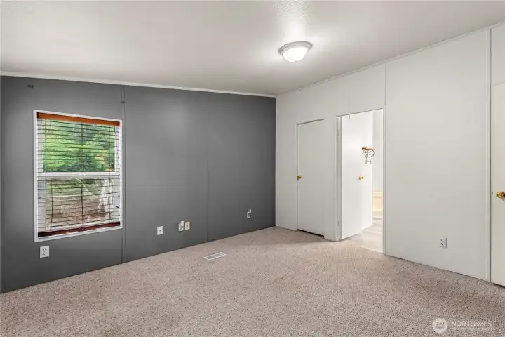 Primary bedroom leading into the primary bathroom!