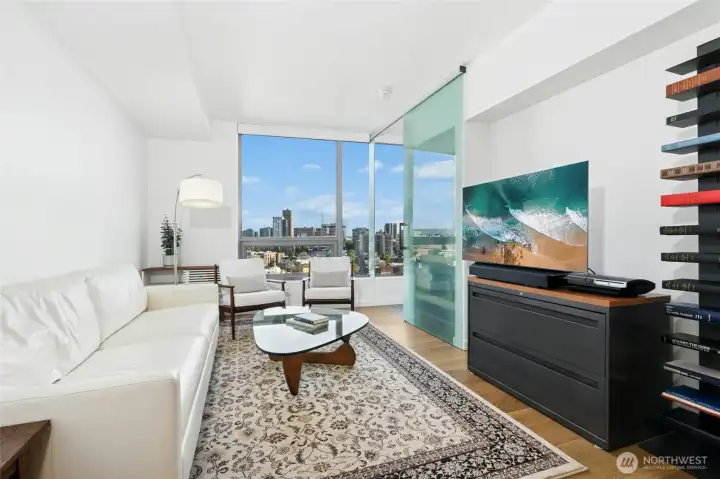 Sunlit living area with modern finishes and city views