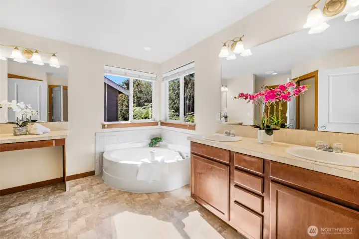 5-peice primary bath with double sink vanity, deep tub, separate glassed in shower and comode.