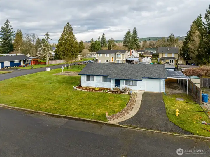 Notice the covered carport next to the garage.  No need to scrape frost off your car.  2 covered spaces...1 garage, 1 carport.