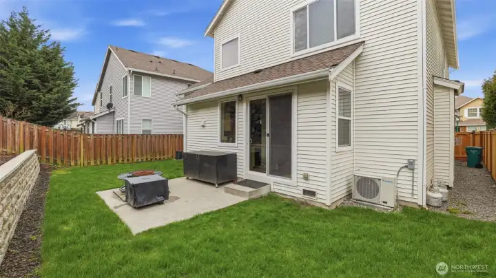 Easy indoor-outdoor living with a cozy patio overlooking a freshly refreshed, professionally landscaped yard.