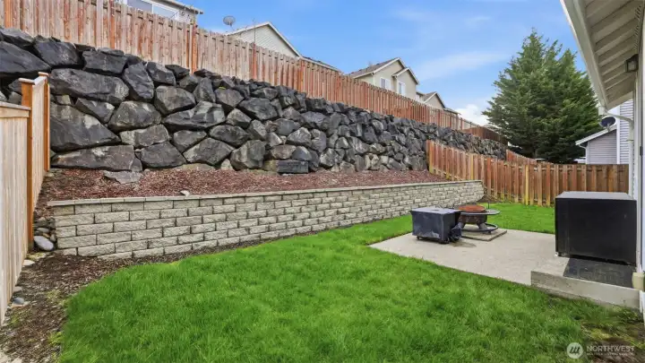 A low-maintenance backyard offering open lawn and a peaceful setting.