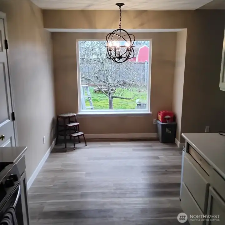 Dining area with new light fixture. Brand new picture window has a view of the Honey Crisp Apple Tree.