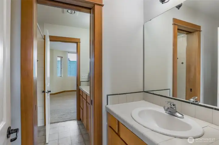 Separate sink and toilet room within the upstairs bathroom.
