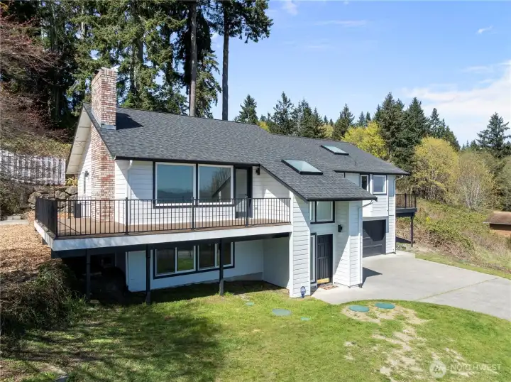 Inviting exterior with classic lines and spacious front lawn.