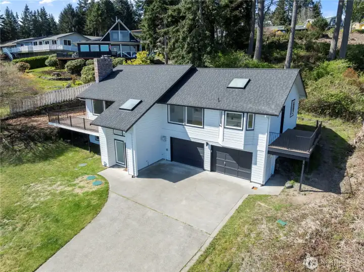 Aerial view showcasing the home’s setting and surrounding landscape.