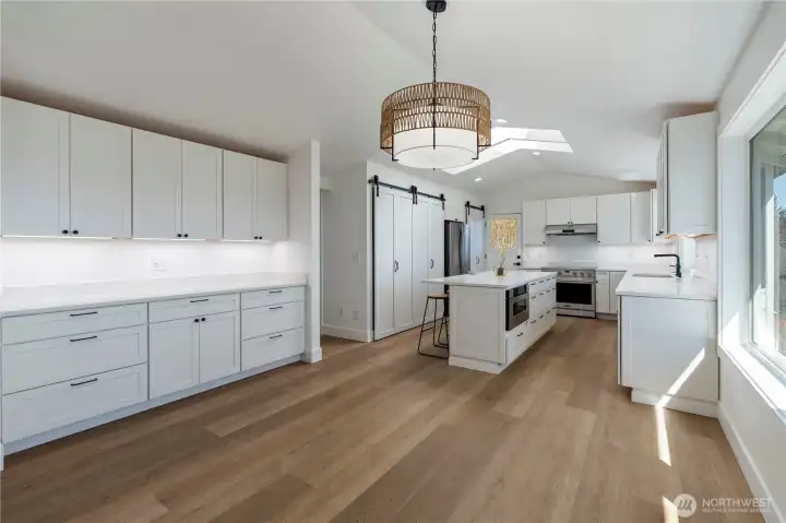Updated kitchen with expansive countertops and ample cabinetry.
