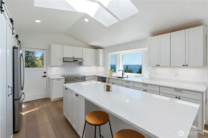 Large island ideal for gathering, prep, and casual dining.