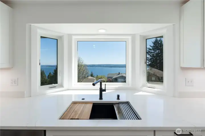 Picture window framing stunning water views from the kitchen.