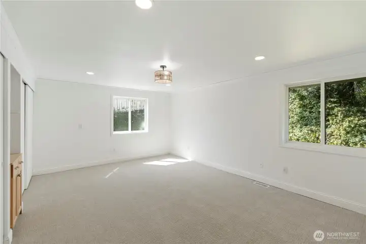 Generous primary bedroom with soft natural light and peaceful outlook.