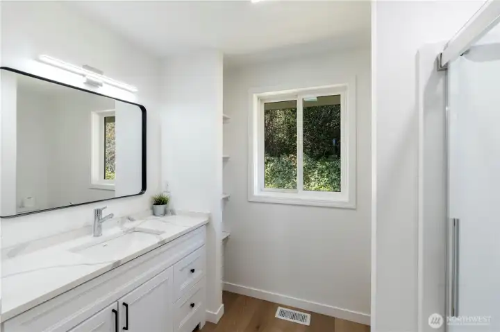 Clean, updated bathroom with modern vanity and fixtures.