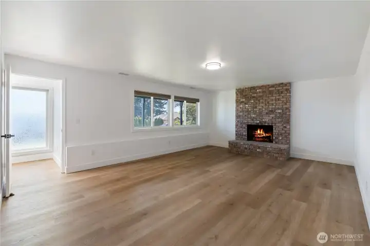 Versatile lower-level living area with fireplace and open layout.