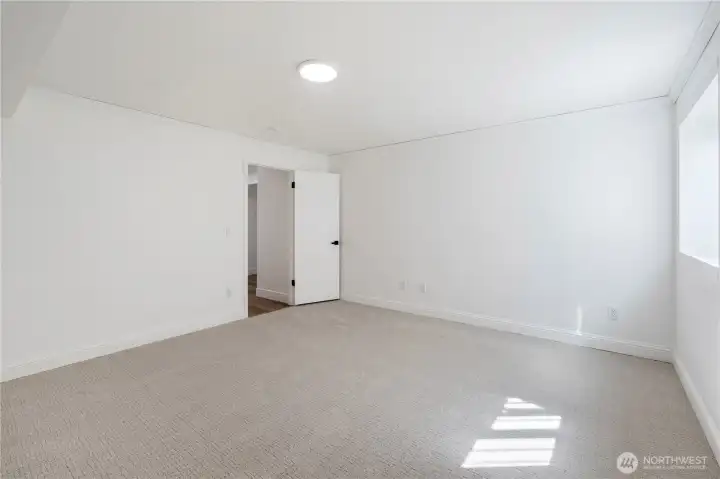 Lower-level room ideal for gym, office, or guest accommodations.