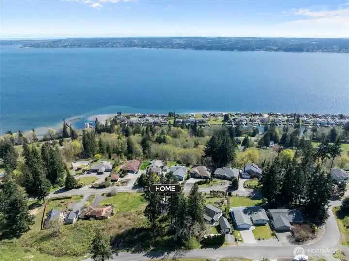 Sweeping panoramic views of the sparkling blue water and serene coastal horizon.