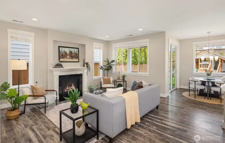 Sunlit family room complete with gas fireplace and walls of windows