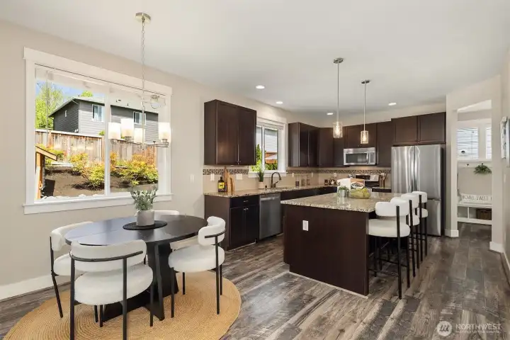 The dining room and kitchen overlook the rear yard
