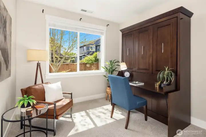 Main floor home office space with built-in muphy bed that also serves as a desk!