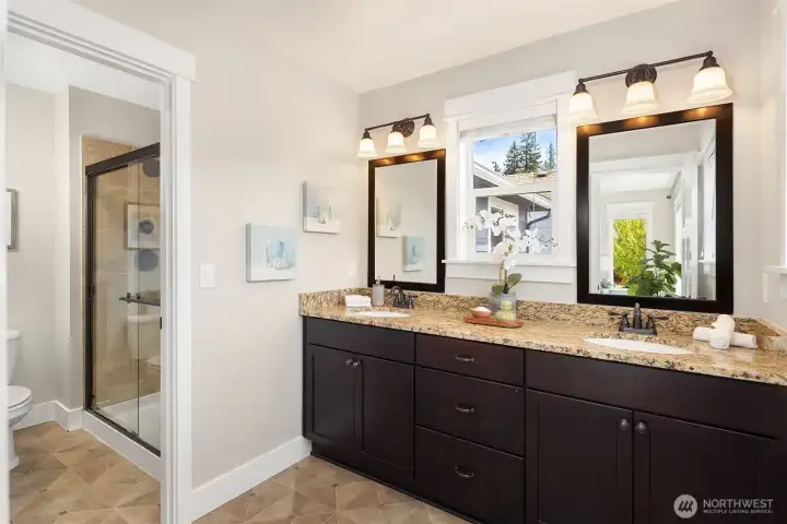 Generous ensuite bath features a double vanity with undermount sinks