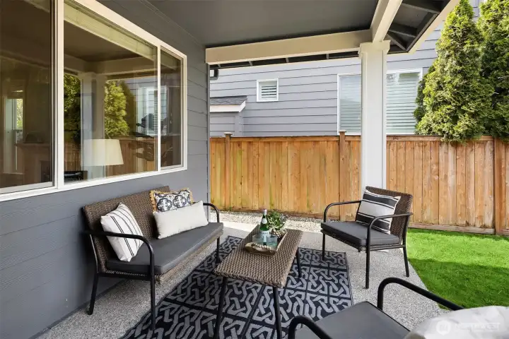 Covered patio offers space for grilling, dining or lounging