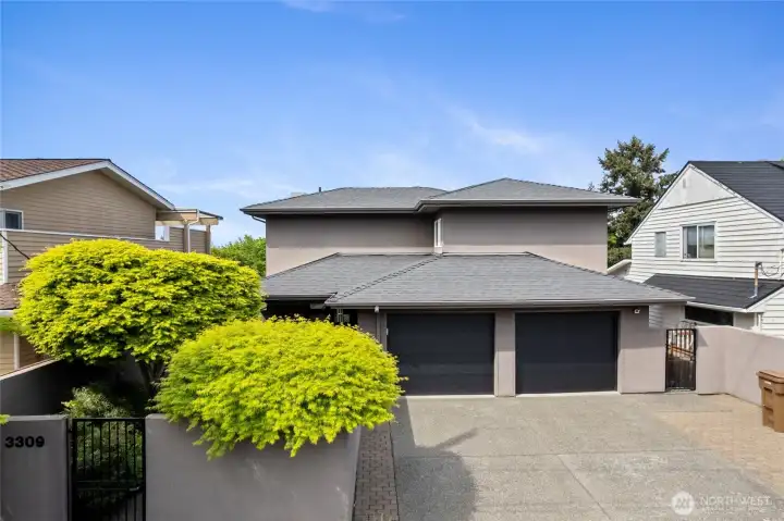 Striking contemporary exterior with clean architectural lines, dual garage, and low-maintenance hardscape. Private, gated entry enhances curb appeal and security.