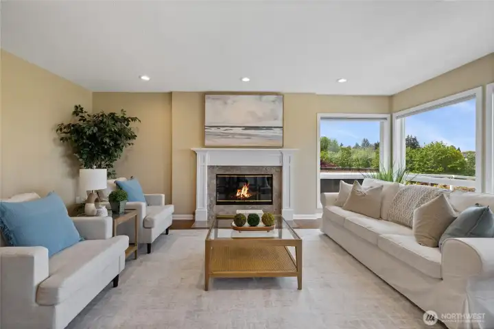 Cozy gas fireplace at center creates ambience for entertaining and this central gathering space.