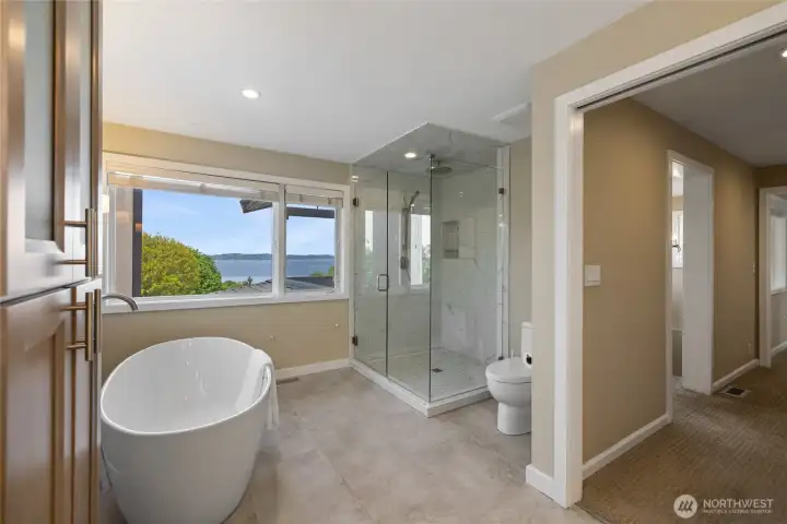 Luxurious en suite bath featuring a freestanding soaking tub, oversized glass-enclosed shower, and tranquil outlooks—designed for spa-like relaxation.
