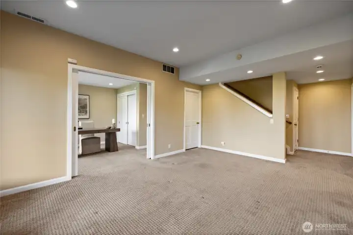 Generous bonus space perfect for media, recreation, or multi-generational living, with convenient proximity to additional rooms and stair access to the main level.
