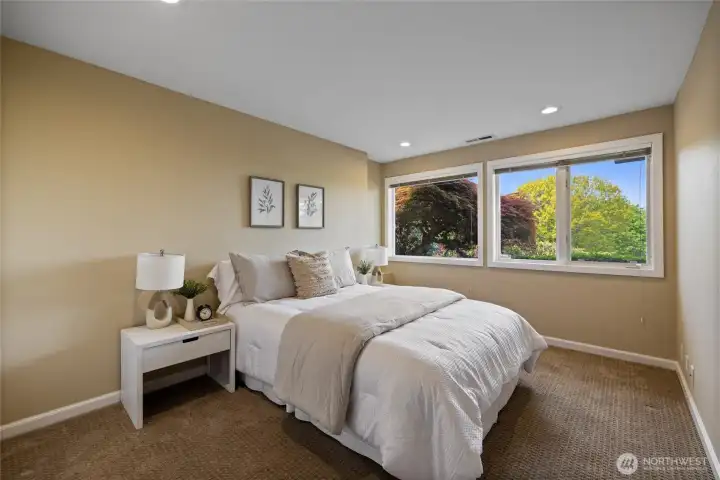Well-sized lower-level bedroom with large windows and ample closet space, offering flexibility for guests or extended stay living. Bright and inviting bedroom with serene outlooks and neutral finishes, easily adaptable for a variety of uses.