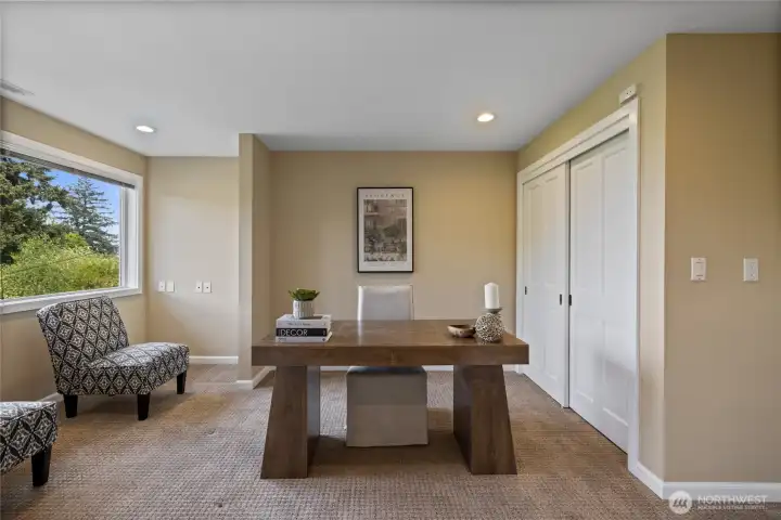 Third bedroom on lower level staged as office, has double door entry - well positioned for bed and sitting area.