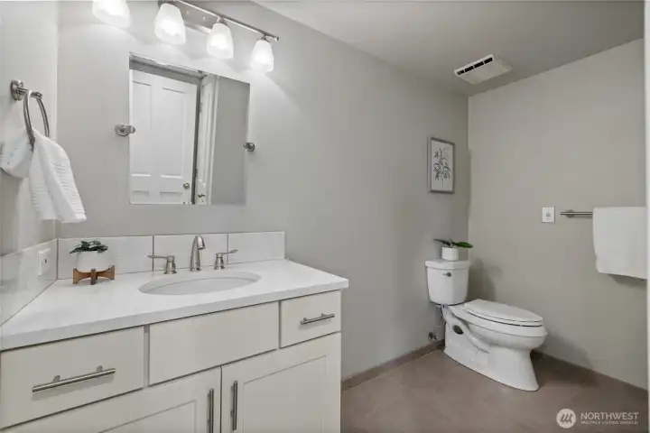 Lower level full bathroom is generous size.