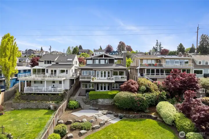 Striking multi-level design with expansive decks and walls of windows, capturing natural light and territorial views while seamlessly connecting indoor and outdoor living. Generous view deck positioned to take in sweeping surroundings—ideal for entertaining, dining, and enjoying sunsets above the lush landscape.