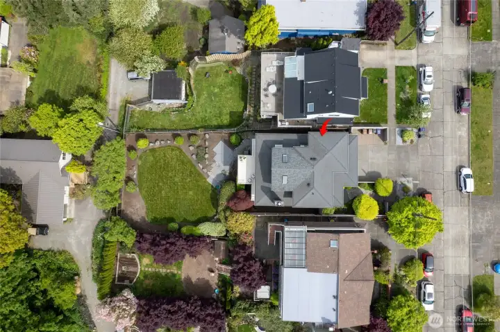 Aerial view of home where it shows alley access for lower level yard space. Larger yard with alley access for possible DADU - Accessory Dwelling Unit.