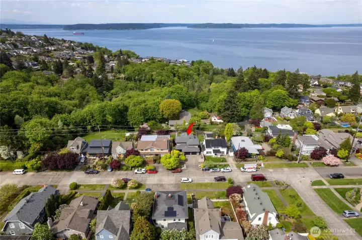 Aerial view highlights the home’s commanding position, generous lot size, and beautifully tiered outdoor spaces. with close proximity to Commencement Bay - enjoy the Wednesday Regatta races. Truly a stunning home you won't want to miss.