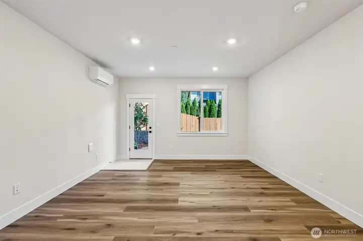 Lower level bonus room offers a great flex space and direct access to the rear yard. Photo is same floor plan on Lot 1-homesite details can vary-see site agent
