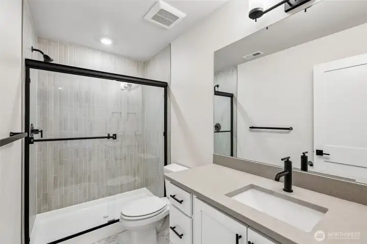 Lower level bathroom showcases upgraded matte-black fixtures. Photo is same floor plan on Lot 1-homesite details can vary-see site agent