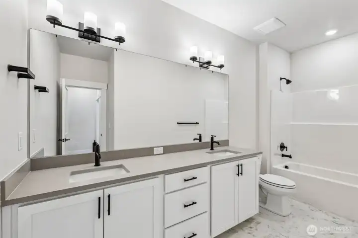 Extra large hall bath features a dual vanity. Photo is same floor plan on Lot 1-homesite details can vary-see site agent