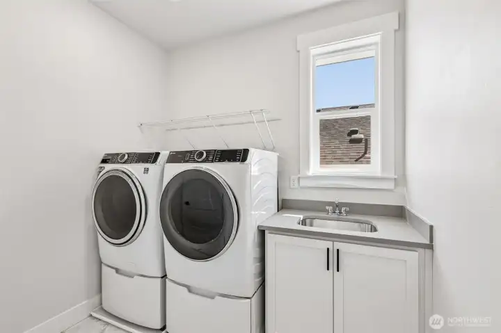 Ideal second floor laundry room with desirable sink/storage cabinet + GE washer/dryer included. Photo is same floor plan on Lot 1-homesite details can vary-see site agent