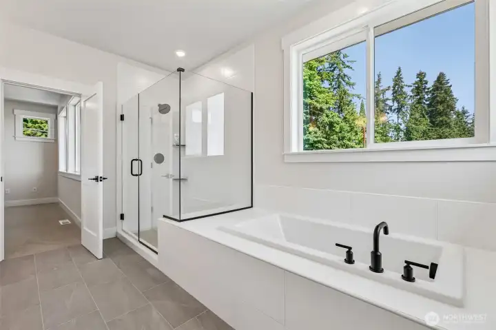Large primary shower with soaking tub invites relaxation. Photo is same floor plan on Lot 1-homesite details can vary-see site agent