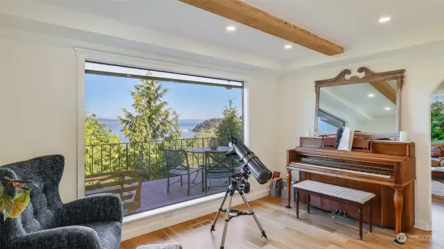 Elegant dining room or music space? You decide! Expansive window enhances the beauty of the surrounding landscape from every angle.