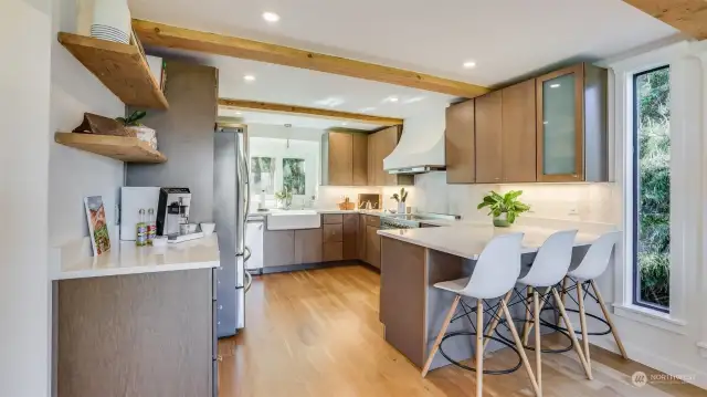 Light pours into this updated kitchen with intimate countertop seating.